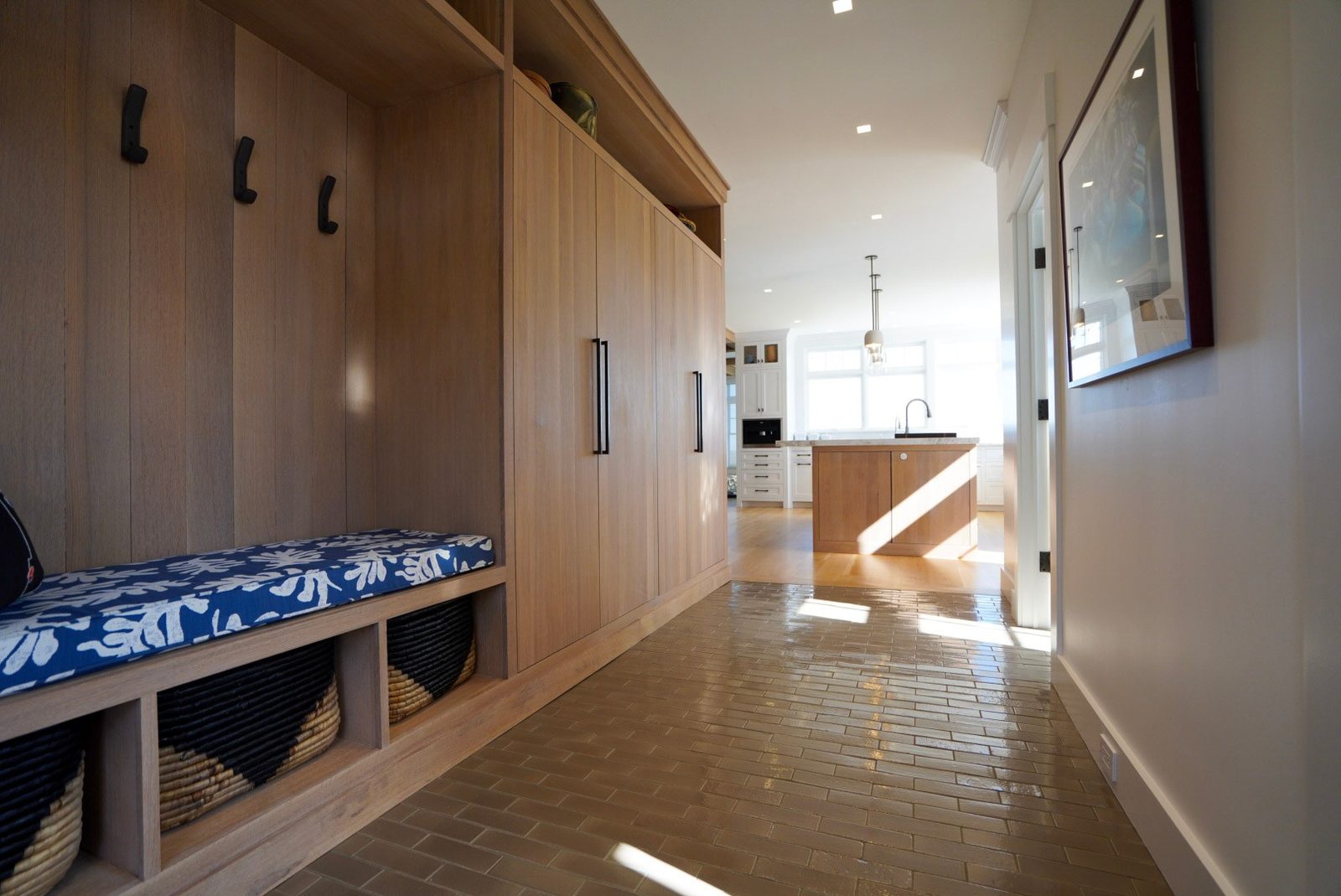 Oak mudroom bench with hooks and baskets, a real Dillon project