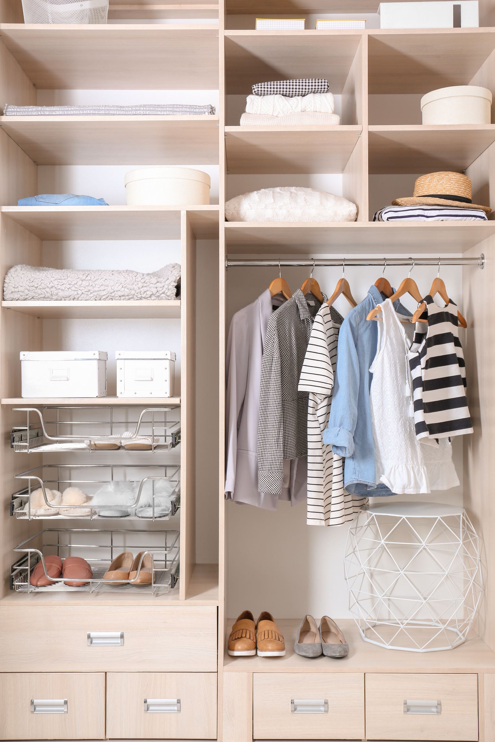 Reach-in closet system with pullout baskets, drawers, shelving, and hanging