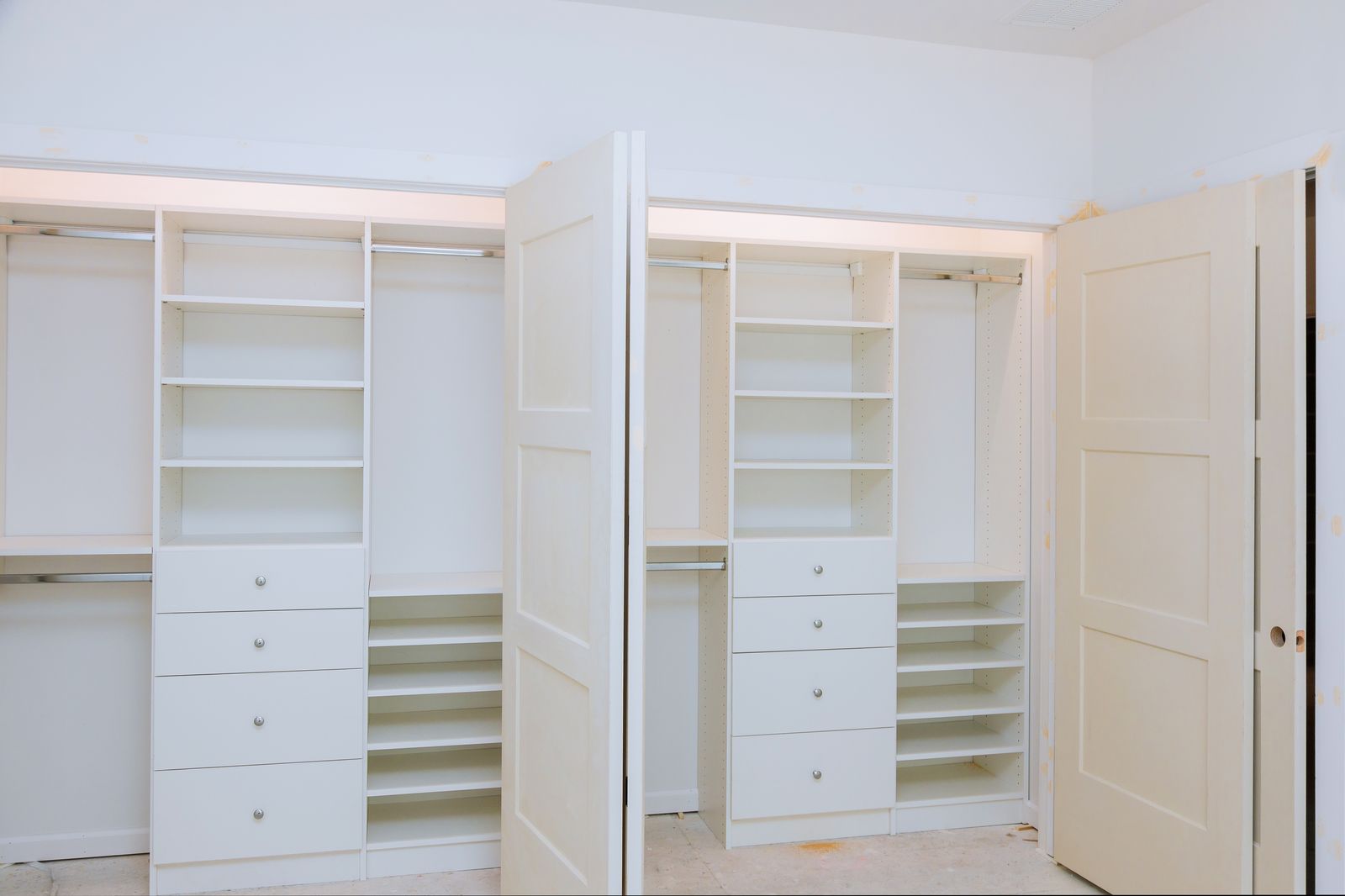 Two reach-in closets fitted with white organizer systems